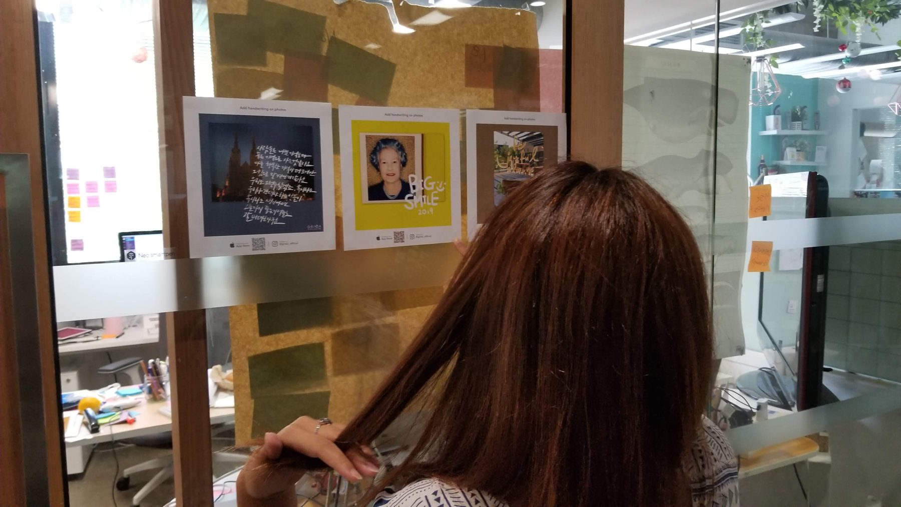 GRIDA prints taped to a glass partition