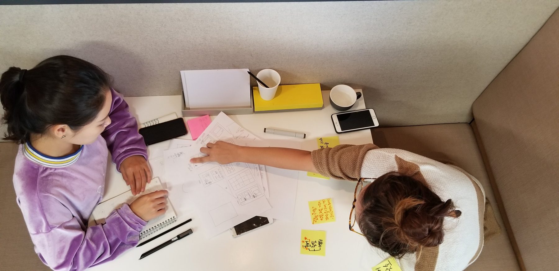 Two designers co-sketching, overhead