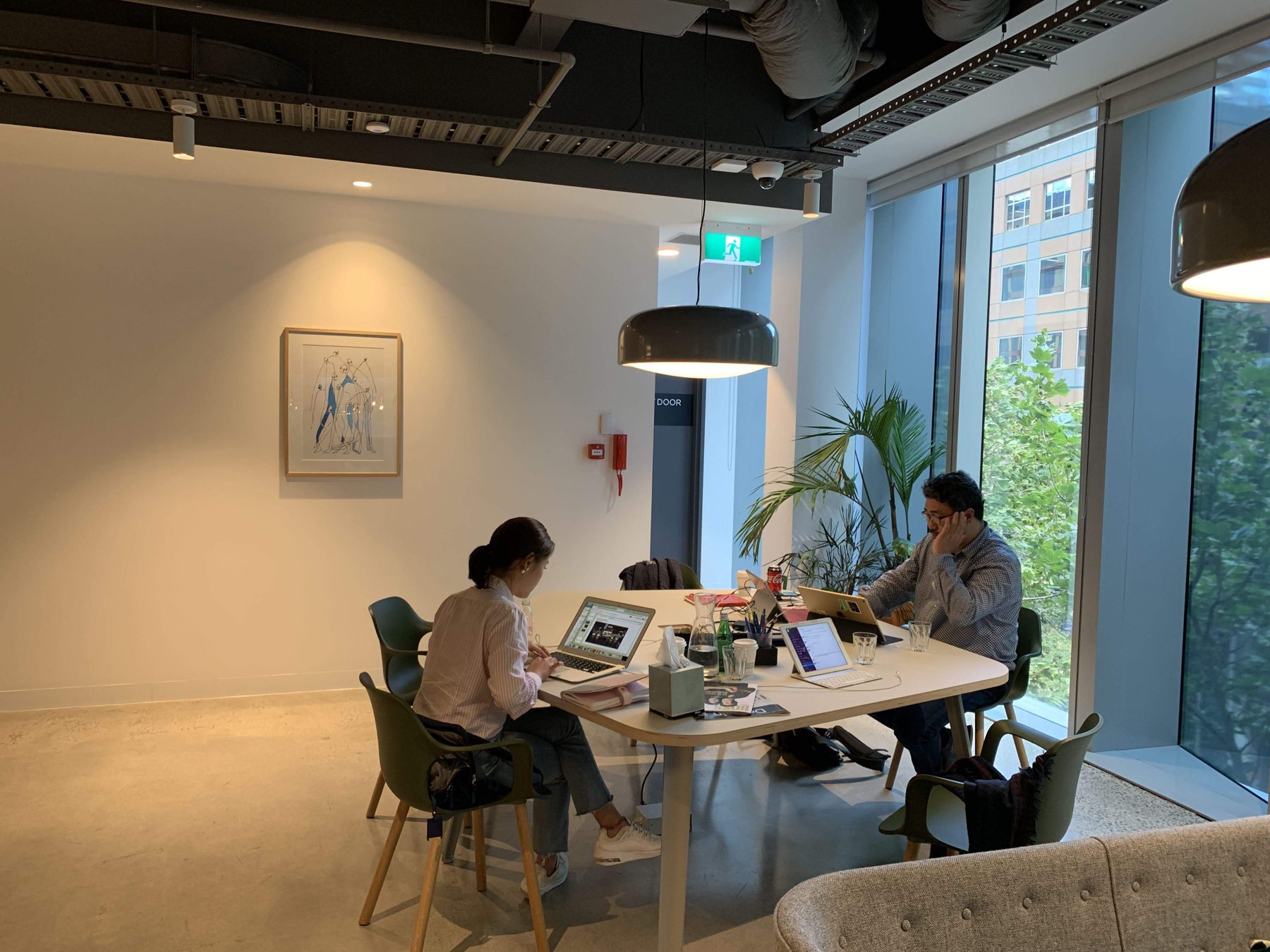 Two people working in the studio lounge