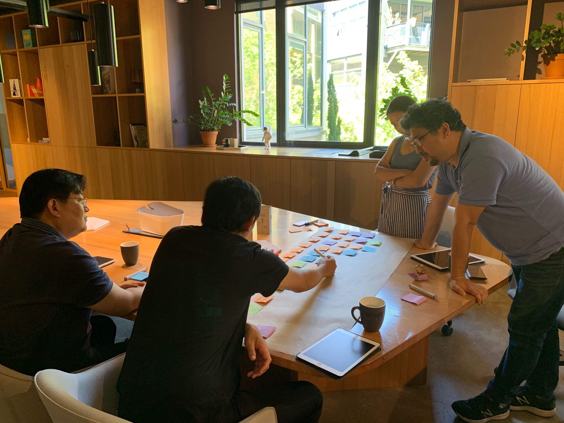 Team sorting colour-coded cards around a table